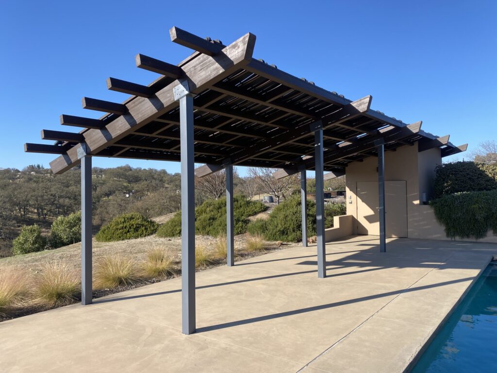 Open pergola structure outside winery before painting