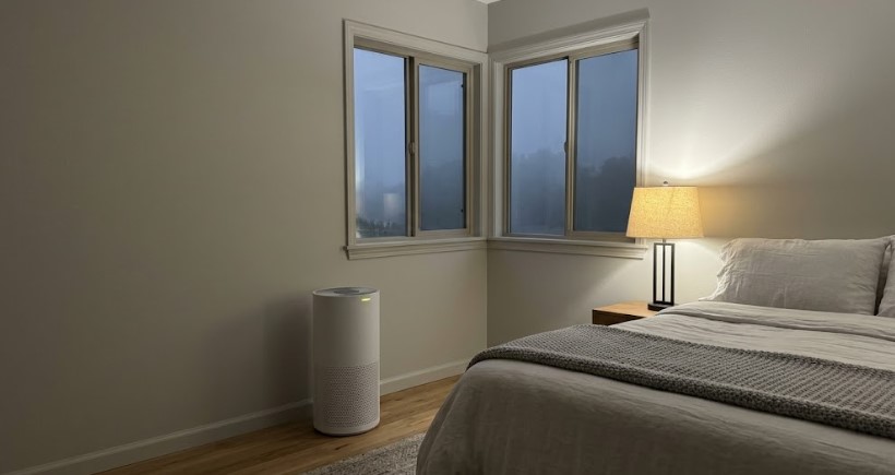 Air purifier running in a closed bedroom on a foggy evening