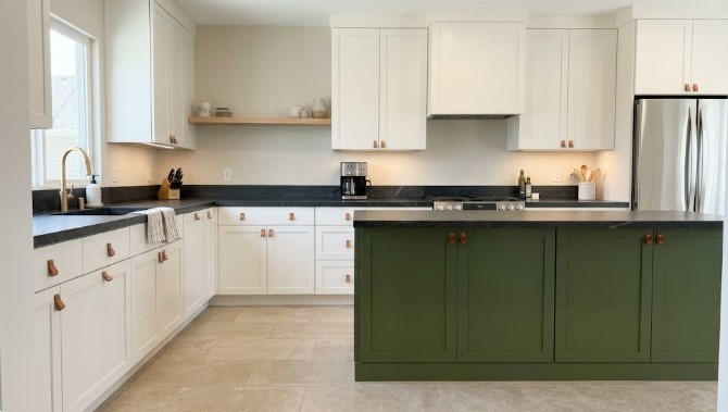 Kitchen with white painted cabinets and green island