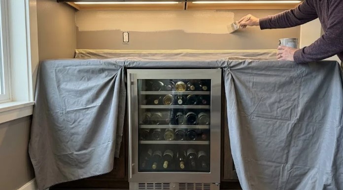 Built-in wine fridge with counter and cabinets covered
